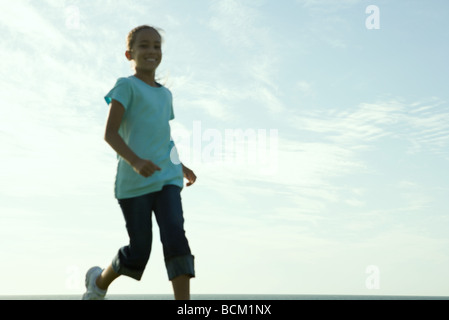 Girl running, low angle view, blurred Stock Photo
