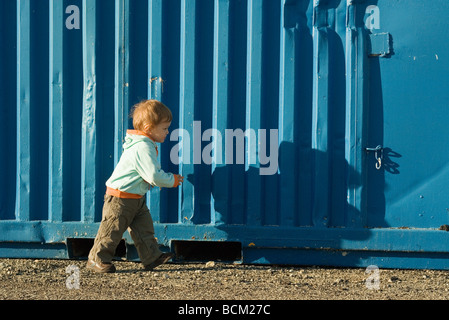 Little boy walking outdoors, side view Stock Photo