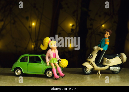 Male toy figure on moped approaching female figure leaning against toy car