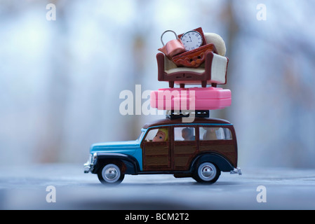 Toy car with luggage and furniture stacked on top Stock Photo