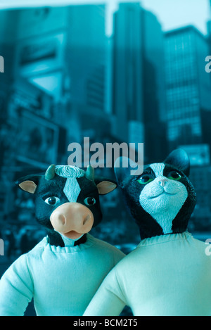 Animal dolls posed in front of city scene Stock Photo