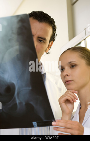 Medical colleagues looking at x-ray, close-up Stock Photo