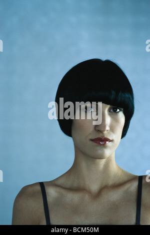 Woman with black hair looking at camera, portrait Stock Photo