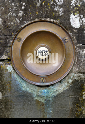 Antique period doorbell push set in stone wall Stock Photo