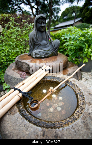 Garden wishing well installation in botanical garden in Tokyo Japan Stock Photo