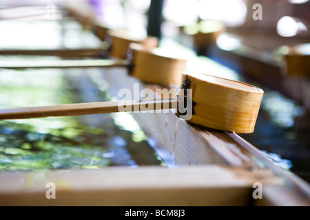 Hand and mouth washing station at Meiji Jingu shrine for people to follow the ritual cleansing before entry into the shrine Stock Photo