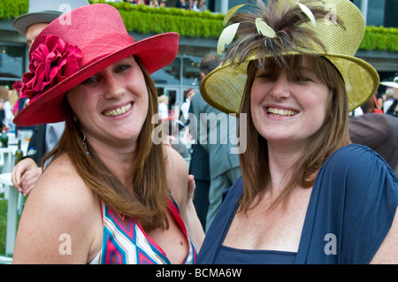Two ladies posing for a photograph at Royal Ascot Horse Races, Ladies Day, Berkshire, England, UK Stock Photo