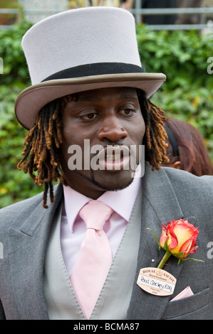 A black man in a top hat and suit at Royal Ascot Horse Races, Ladies Day, Berkshire, England, UK