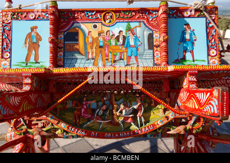 Traditional Sicilian folk art on a wooden cart depicting folk tales of Sicily Stock Photo