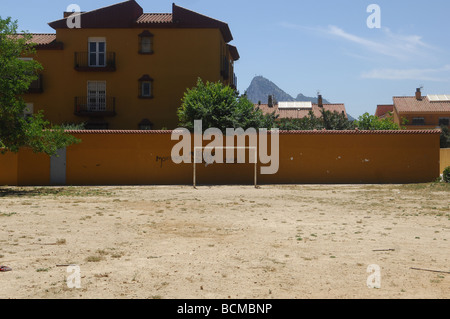 A rough, dirt football pitch with the Rock of Gibraltar in the background. Stock Photo