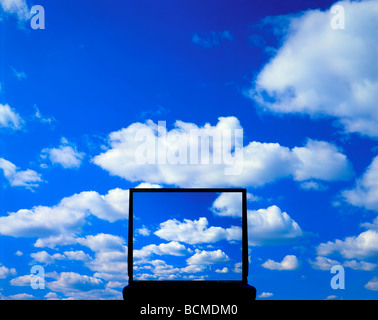 laptop computer with fluffy white clouds on monitor with same clouds in background Stock Photo