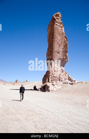 Man in front of rock formation, known as the Pakana Monks, near Tara Salt Lake, Chile Stock Photo