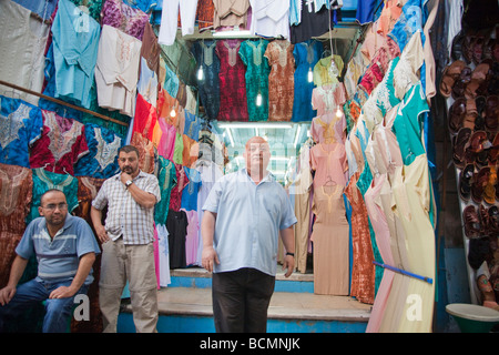 A shopkeeper sells traditional Tunisian clothing in the Medina (old city) in Tunis. Stock Photo