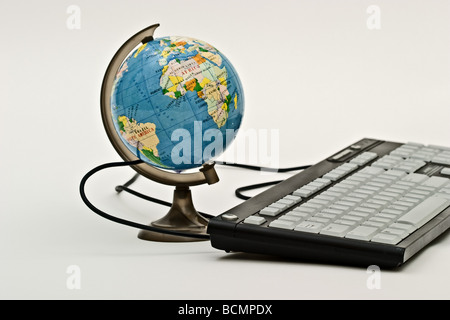 A computer keyboard connected to a globe Stock Photo - Alamy