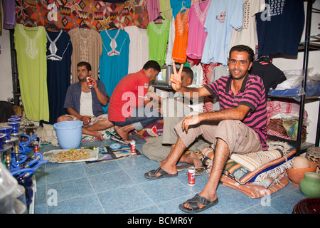 A shop in Tozeur, Tunisia sells rugs, clothing, and other traditional handicrafts to tourists. Stock Photo