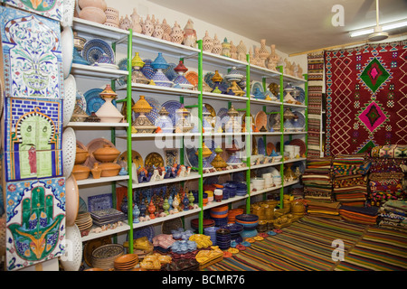 A shop in Tozeur, Tunisia sells rugs, clothing, and other traditional handicrafts to tourists. Stock Photo