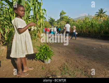 A young girl sells herbs along a long dirt road leading in the village of Ville Bonheur during Saut D'eau on July 15, 2008. Stock Photo