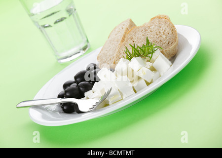 Feta cheese, black olives and bread Stock Photo