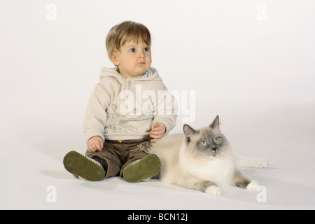 small boy - sitting next to Neva Masquarade - cut out Stock Photo