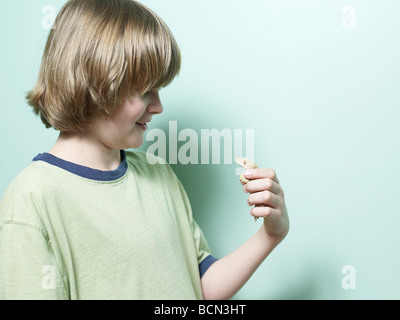 Boy Holding Lizard in Hand Stock Photo