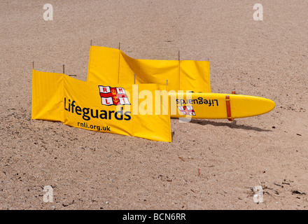 Surf board and windbreak displaying the RNLI logo