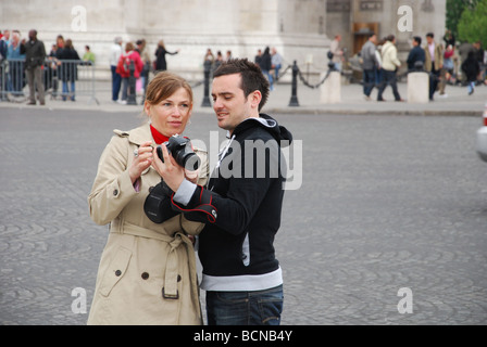 couple checking self portrait in front of Notre Dame Paris France Stock Photo