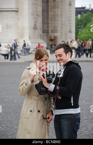 couple checking self portrait in front of Notre Dame Paris France Stock Photo