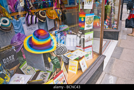 Colourful novelty hats, gifts and cards on display in a shop window. Seaside town of Swanage, Dorset. UK. Stock Photo