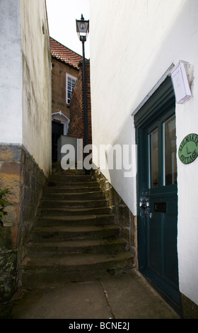 An typical narrow alleyway in 'Robin Hoods Bay', North Yorkshire, England, UK. Stock Photo