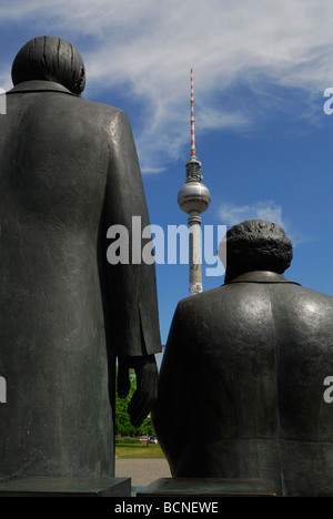 Berlin Germany Staue of Karl Marx right Friedrich Engels on Marx Engels Forum facing the Furnsehturm TV tower on Alexanderplatz Stock Photo