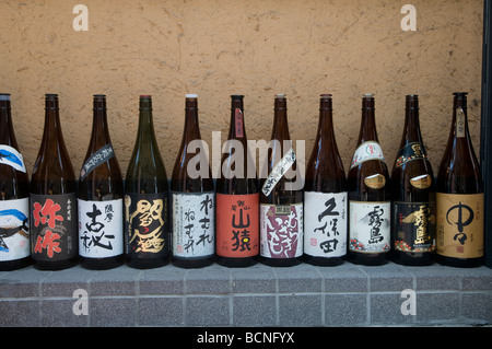 Saki bottles on display outside restaurant in Tokyo Japan Stock Photo