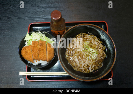 Traditional lunch known as a teishoku featuring Source Katsudon (rice bowl with deep-fried pork) and Kake Soba hot buckwheat noodle soup, Japan Stock Photo