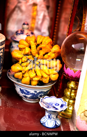 Buddha In A Vietnamese Temple With Offerings Including Flowers And The 