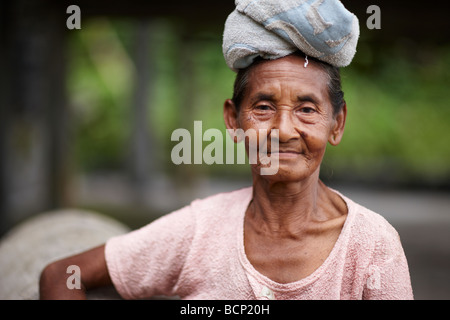 lady with towel on head for carrying loads, nr Tirtagangga, Bali, Indonesia Stock Photo