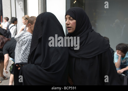 Muslim women wearing full face covered up burka London 2009 2000s UK. HOMER SYKES Stock Photo