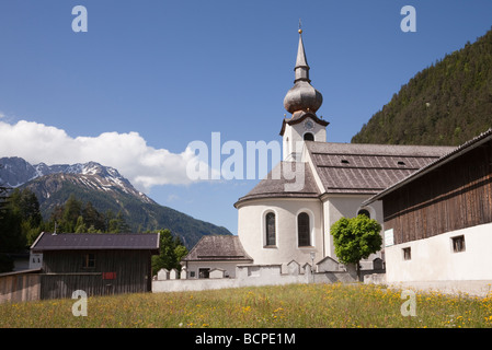 St. Rochus Chapel in Alpine village with flower meadow in summer. Biberwier, Tyrol, Austria, Europe Stock Photo