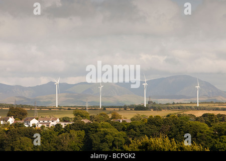 Wind turbines on the outskirts of Workington Cumbria UK with the Lake District hills beyond Stock Photo