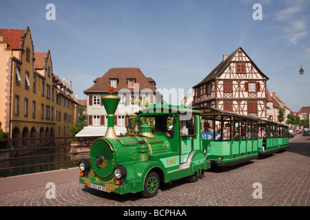 Colmar Haut-Rhin Alsace France Europe. Tourists on little train sightseeing tour in 'Little Venice' area of the old town Stock Photo