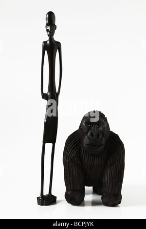 Hand made wood carvings from Africa, of an African tribesman and Gorilla Stock Photo