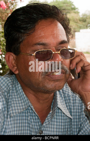 Businessman talks on mobile telephone India Stock Photo