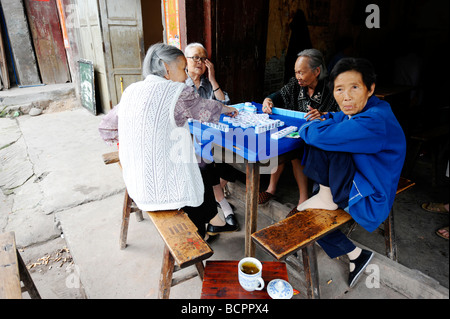 Four elderly Chinese woman playing Mahjong in a local teahouse, Lizhuang Ancient Town, Sichuan Province, China Stock Photo