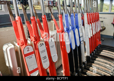 Levers on a lever frame in a manually operated signal box to operate points and signals Stock Photo