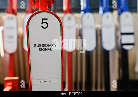 Levers on a lever frame in a manually operated signal box to operate points and signals Stock Photo