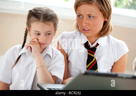2 girls using on laptop Stock Photo
