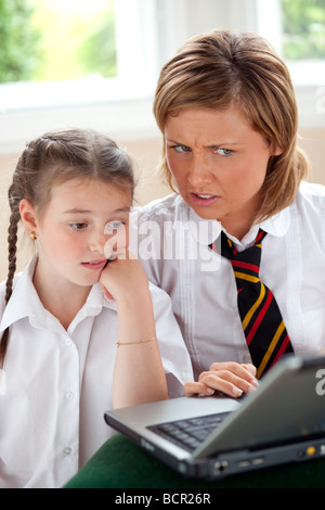 2 girls using on laptop Stock Photo