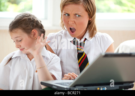 2 girls using on laptop Stock Photo