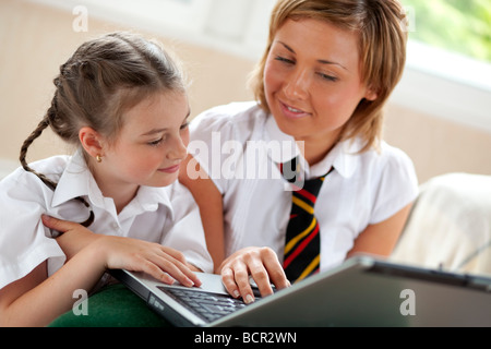 2 girls using on laptop Stock Photo