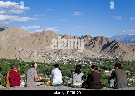 Ladakhi people contemplating Leh from Shanti Stupa viewpoint. Leh. Ladakh. India Stock Photo