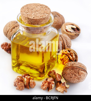 Walnut oil with nuts on a white background Stock Photo