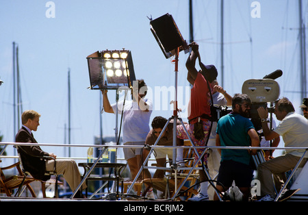 film production crew lighting a scene Stock Photo